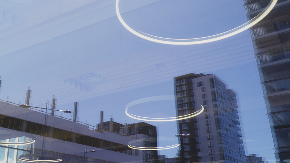 Lamps reflecting on windows. Buildings in background