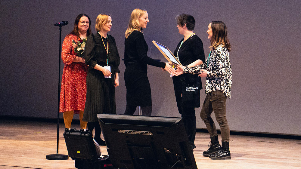 Nuorisoasioista vastaava ministeri Sandra Bergqvist onnittelee palkinnonsaajia.